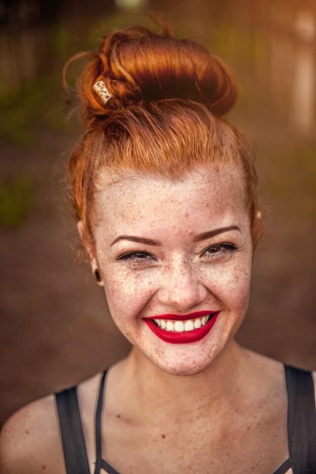 Uma moça ruiva sorrindo
